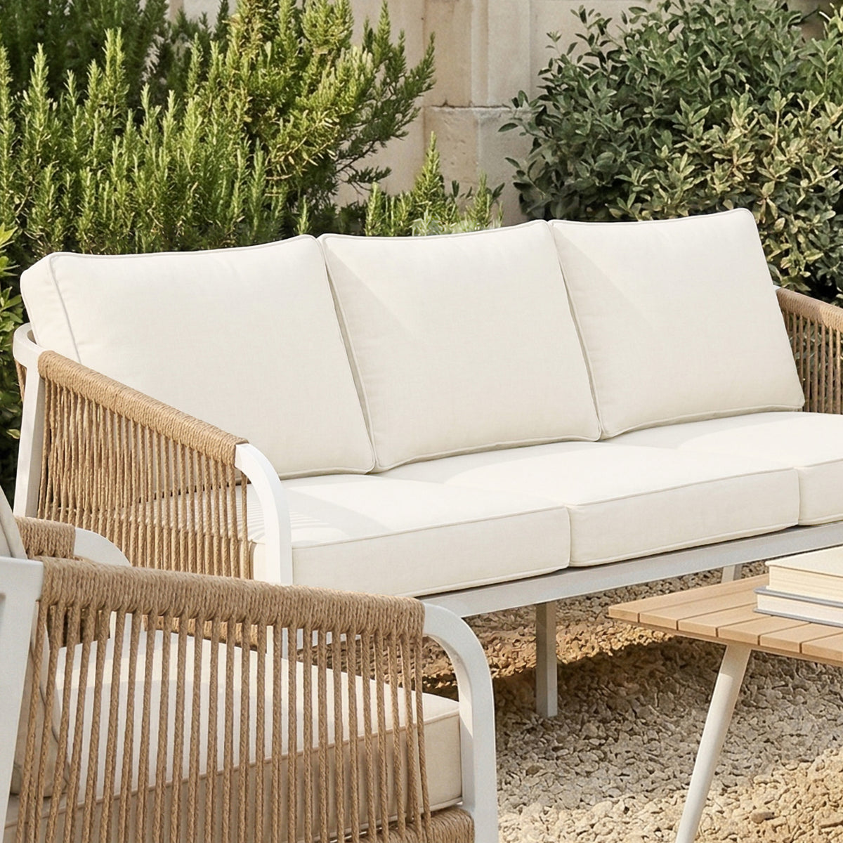 Vernon Outdoor Cushion Covers Set of 5 in Cream White neatly fit on off-white cushions of metal-framed armchairs and sofa, enhancing the modern outdoor lounge with durability and style.
