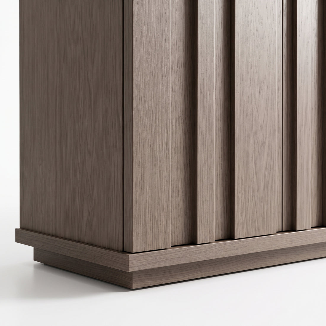 Close view of the lower section of a wooden cabinet on a white background