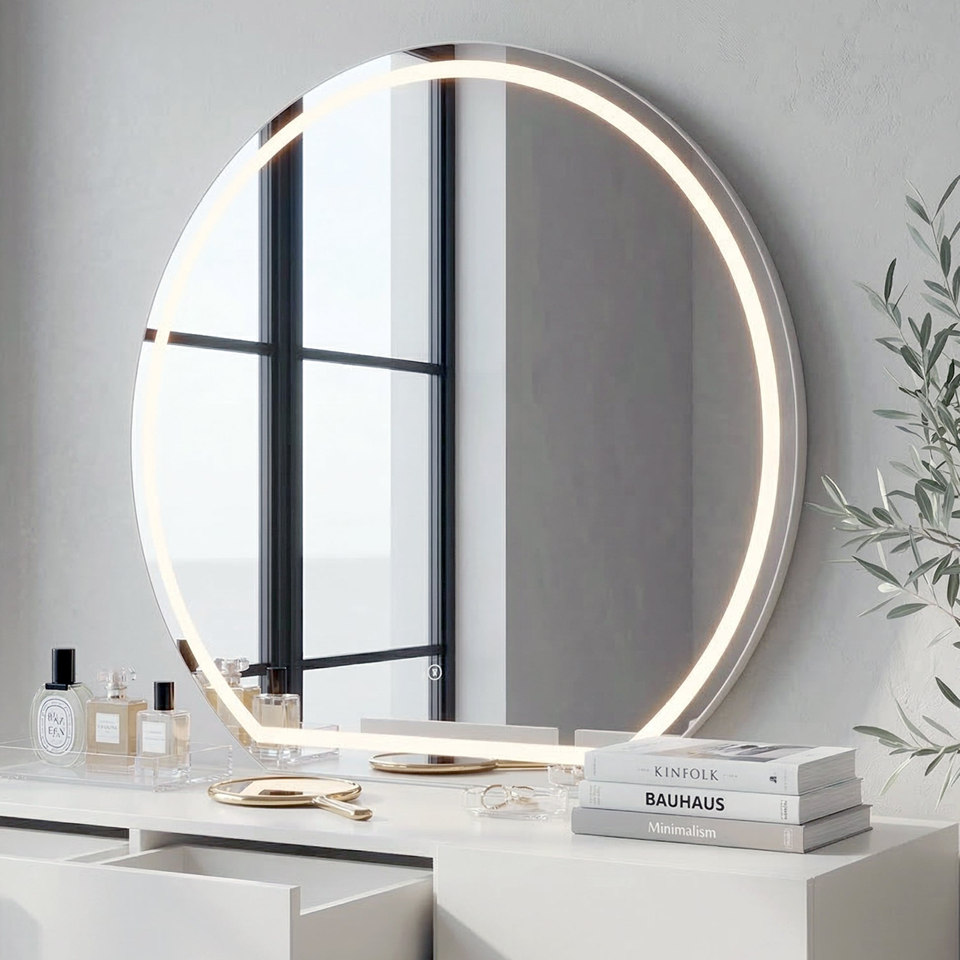 Round LED mirror mounted above white vanity table with decorative items in a modern room