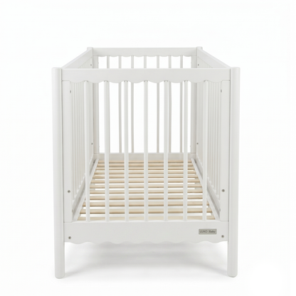 Front view of white wooden baby crib on a white background