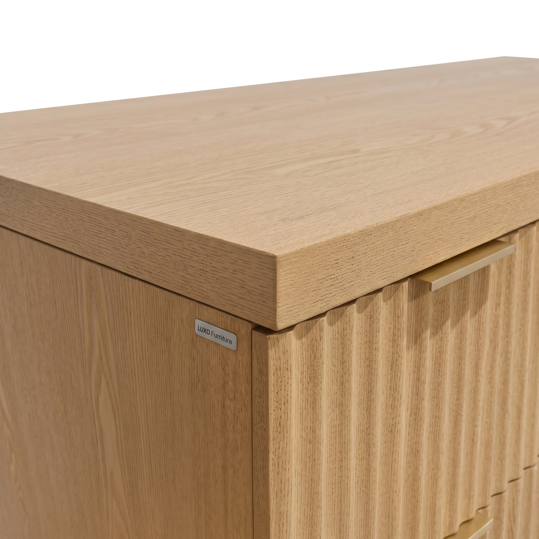 Close-up detail of a light wood cabinet corner and handle on white background