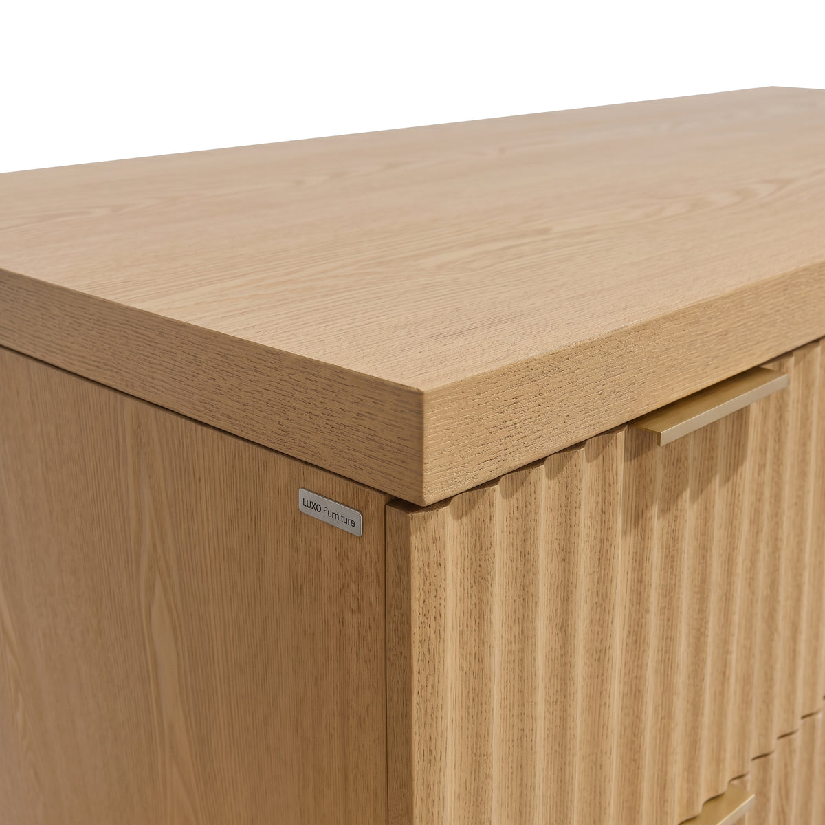 Close-up detail of a light wood cabinet corner and handle on white background