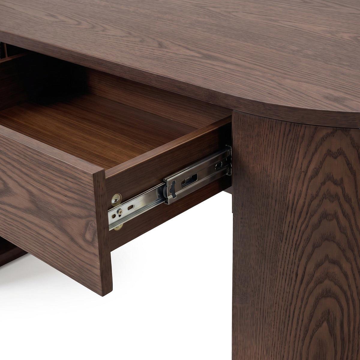 Close-up of an open drawer on a dark wood desk showing the drawer interior and slide hardware