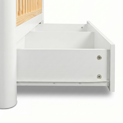 Close-up of crib drawer pulled out on white background