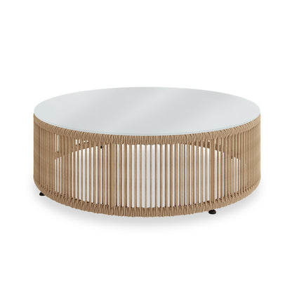 Solari 4 Seater Wicker Outdoor Sofa Set in Natural features a low, round coffee table with a smooth white tabletop and a cylindrical base wrapped in natural-colored woven rope.