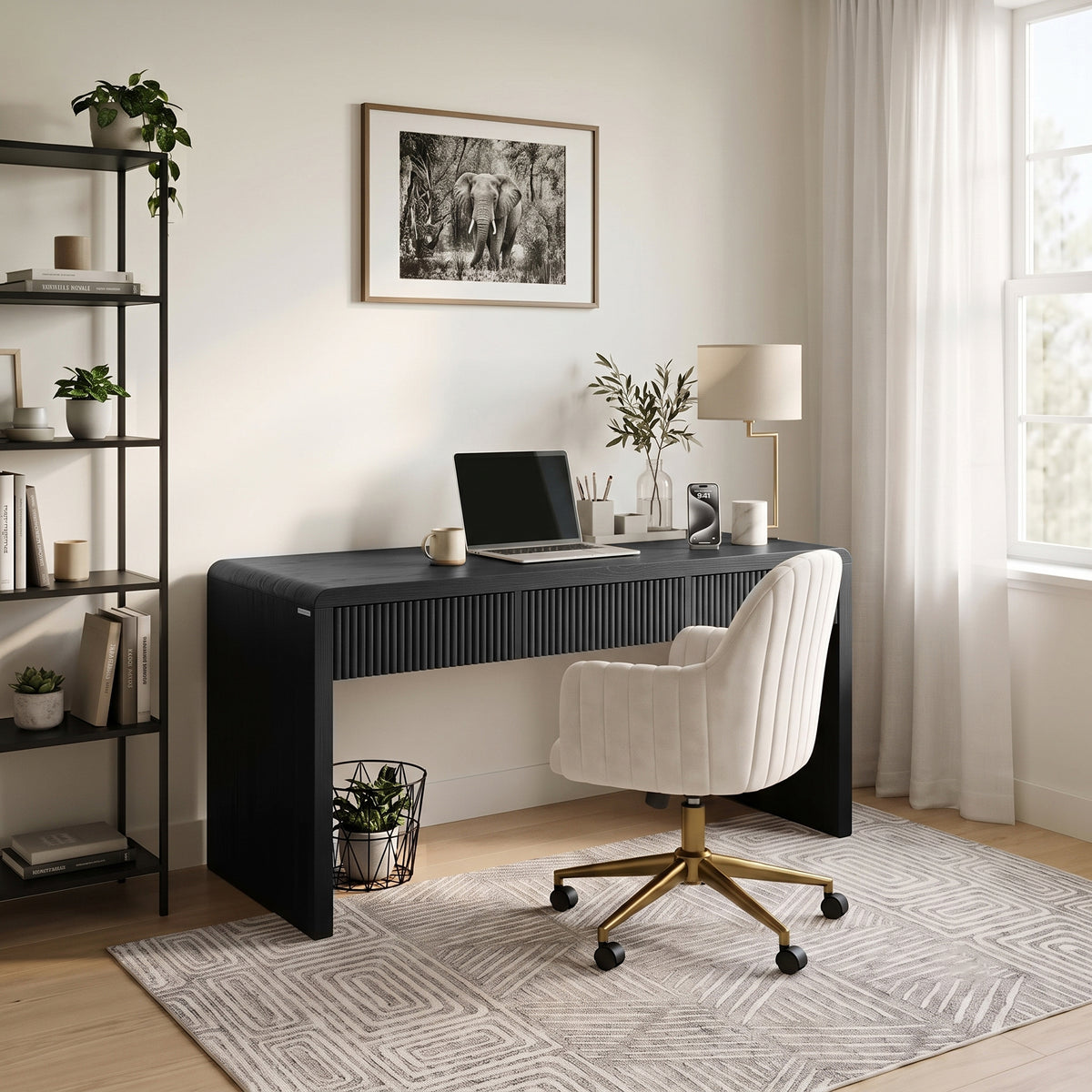 Modern black desk in a bright home office setting with accessories