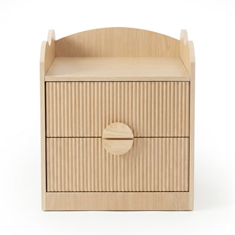 Modern light wood nightstand with ribbed drawers on white background