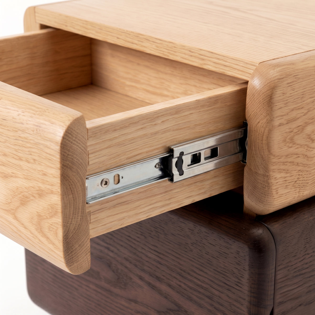 Close-up of a partially open wooden drawer showing craftsmanship and metal slide on a white background