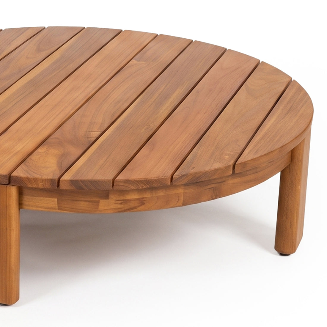 Close-up partial view of a round wooden table on white background
