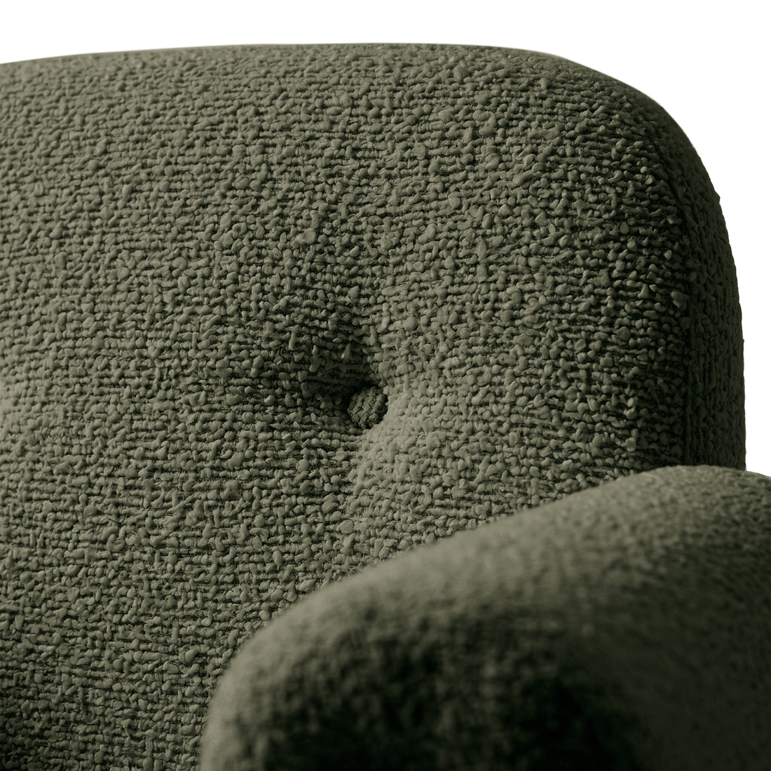 Close-up of textured green boucle fabric and button tuft