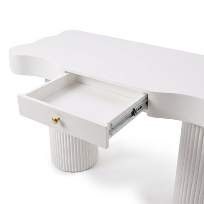 Close-up of a white desk drawer with gold knob and fluted leg detail on a white background