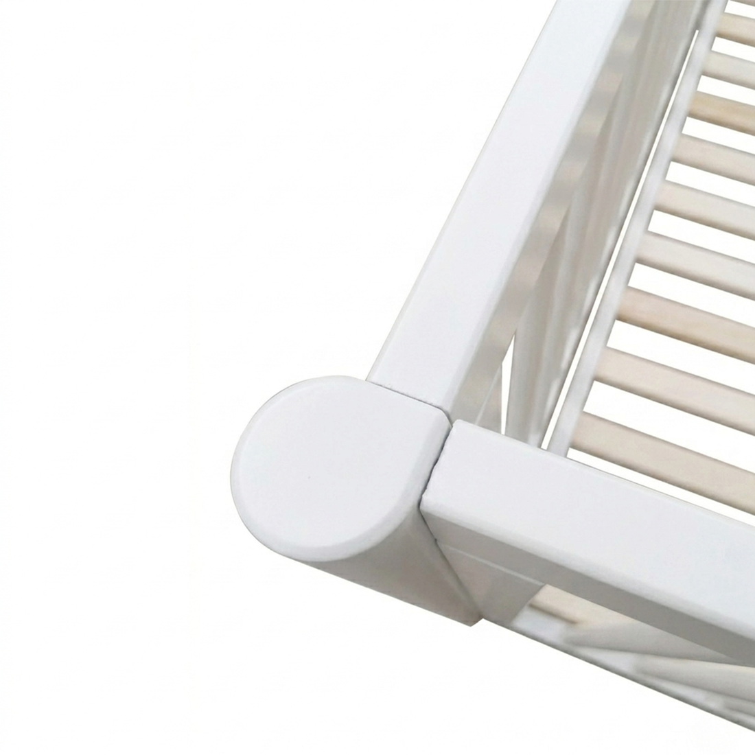 Close-up of corner joint of white wooden crib frame on white background