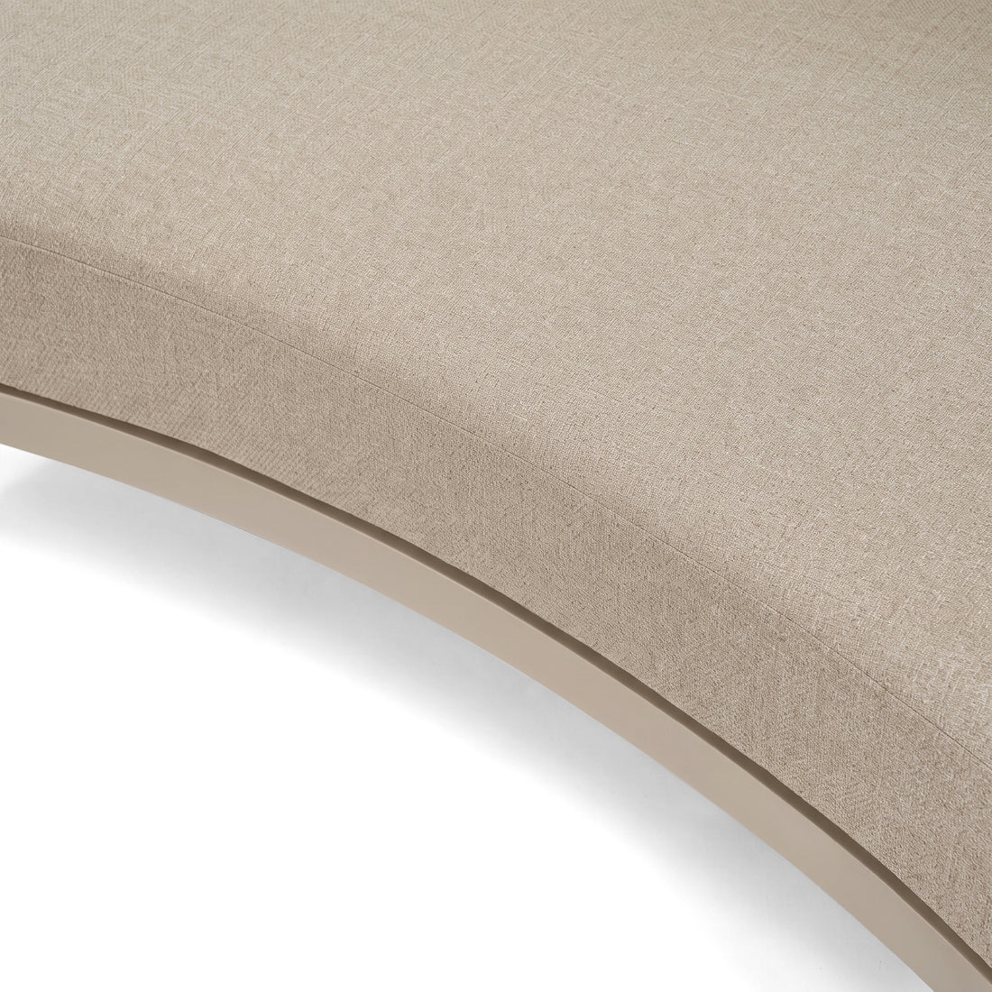 Close-up of curved beige upholstered furniture on a white background