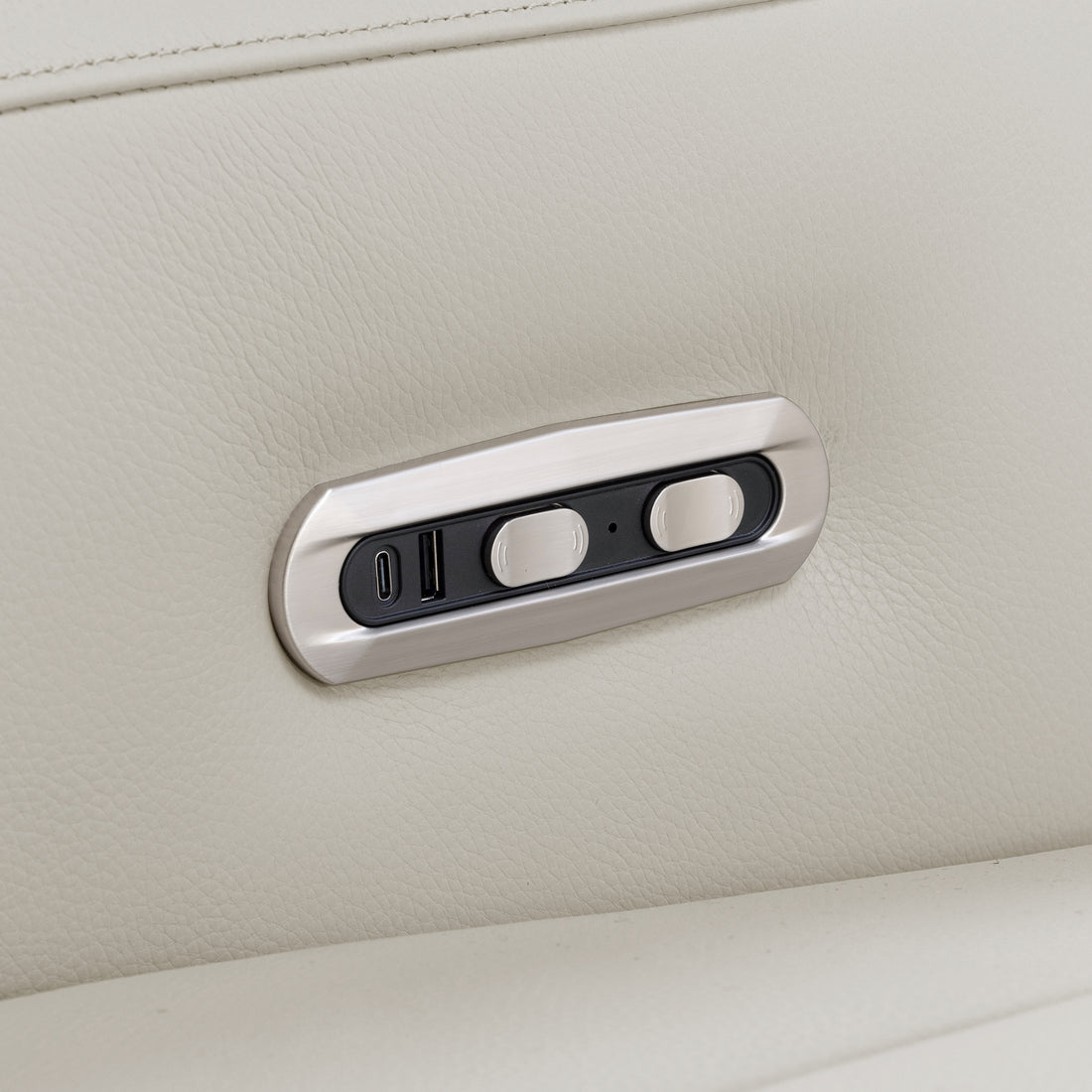 Close-up of a sofa control panel in beige upholstery.