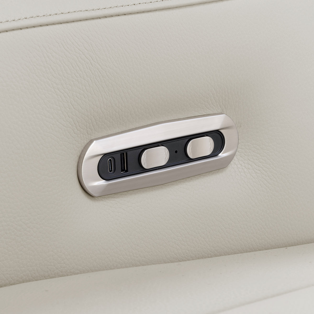 Close-up of a sofa control panel in beige upholstery.