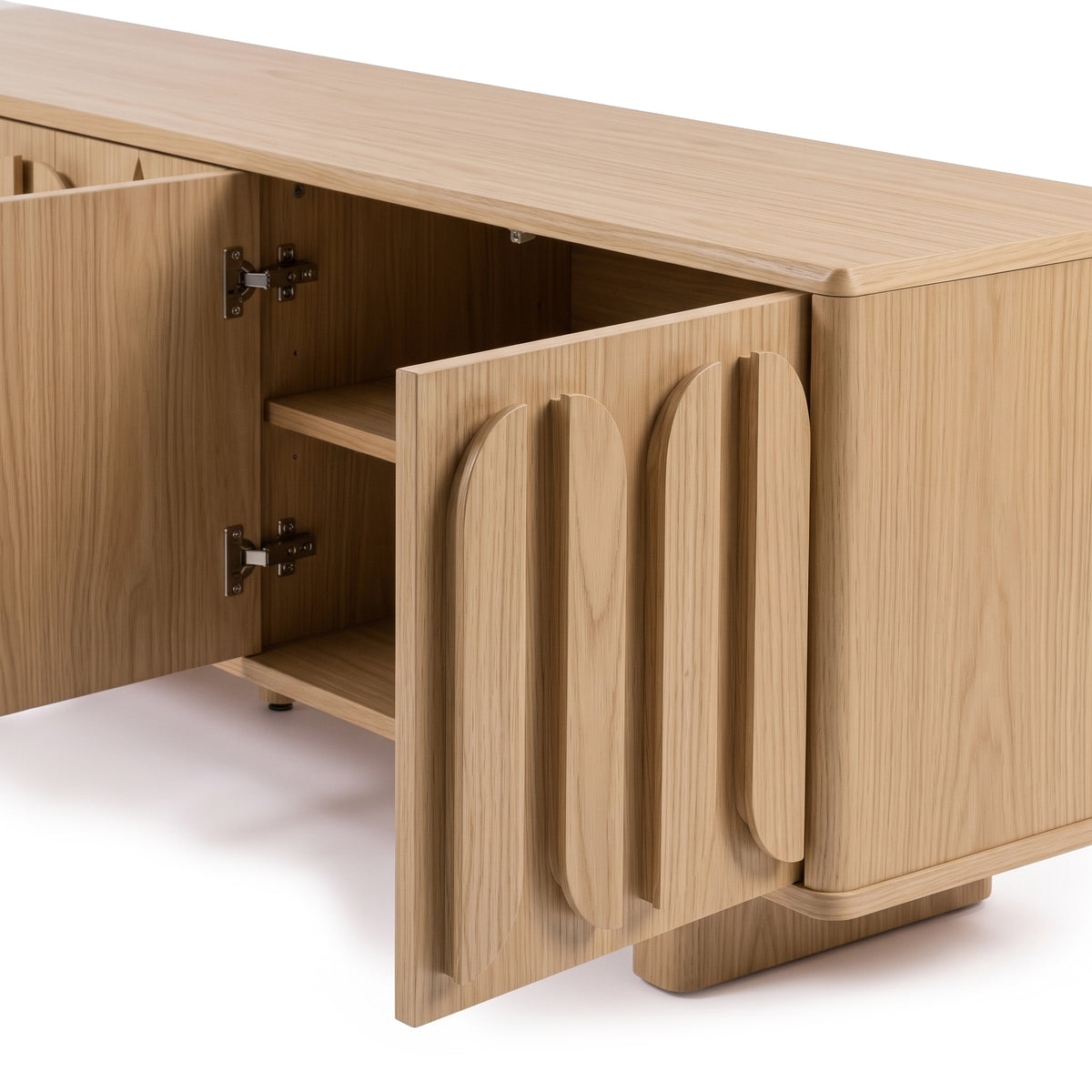 Partially cropped wood sideboard on a white background with open doors