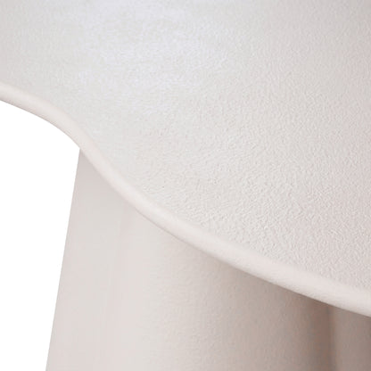 Close-up of a light-colored textured surface and curved furniture edge on a white background