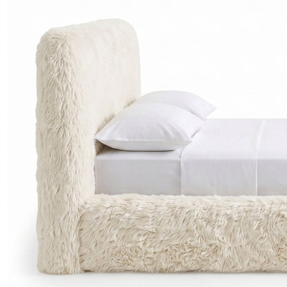 Cropped close view of a plush upholstered bed on a white background