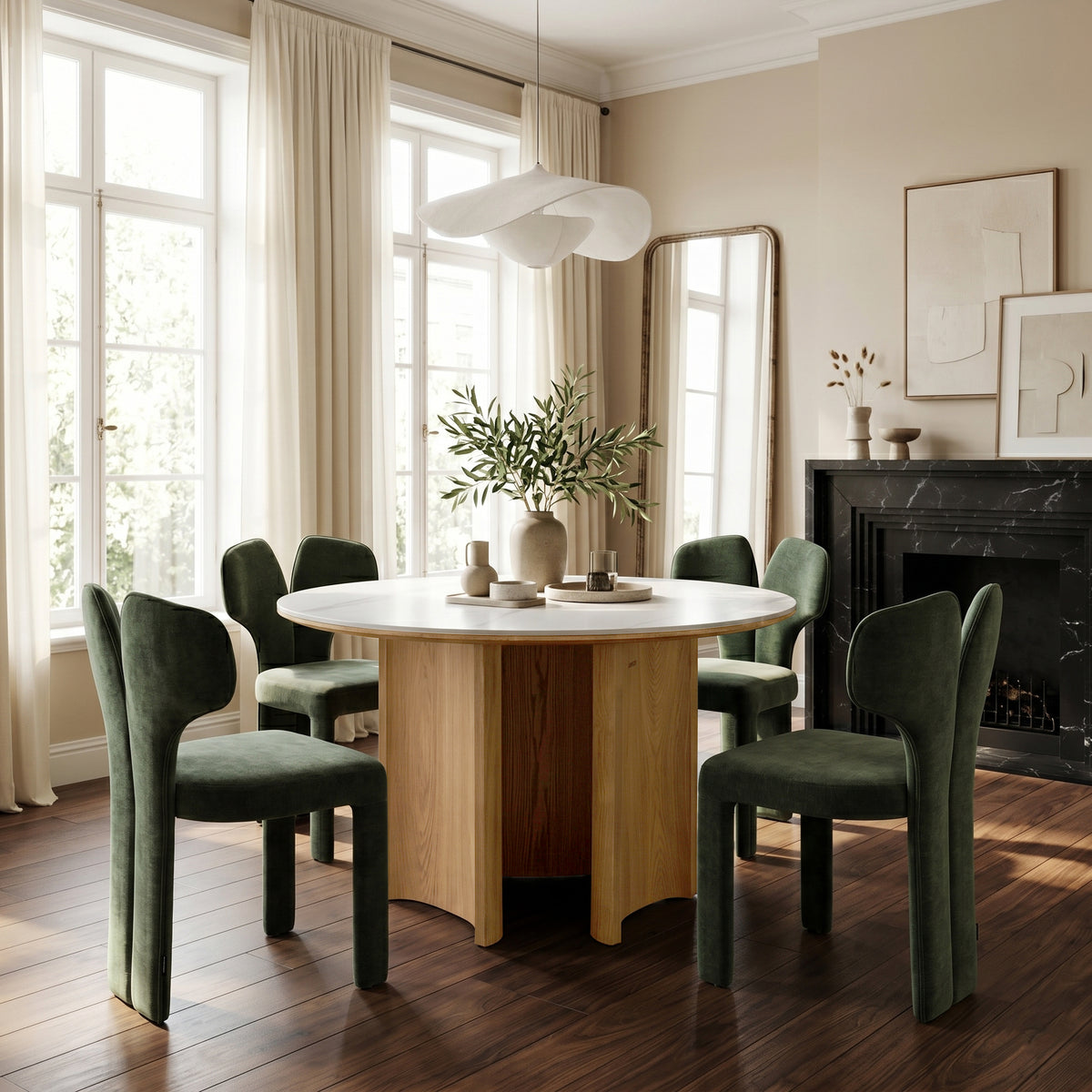 Dining table set with four green chairs in a bright dining room