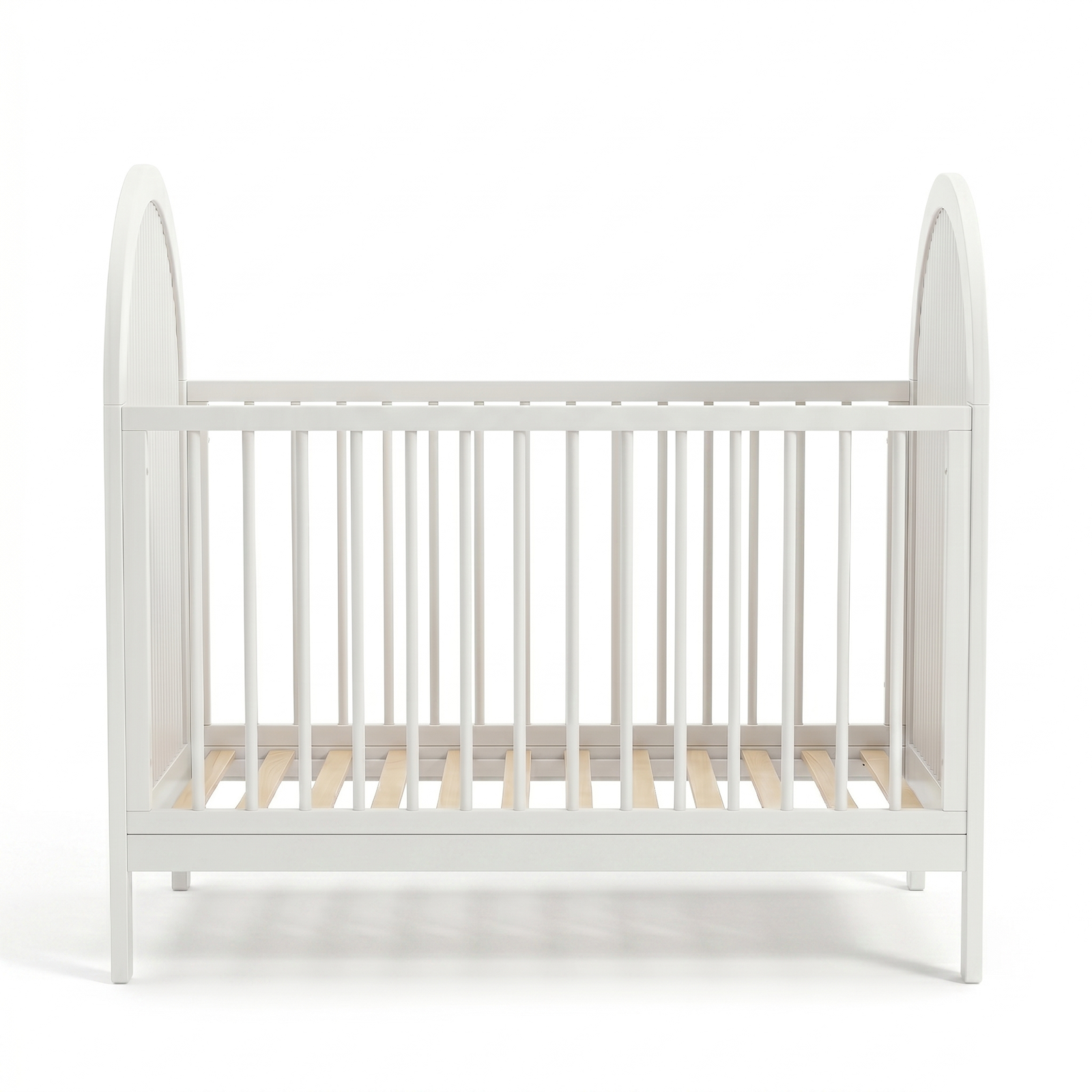 Symmetrical front view of white crib with arched sides and evenly spaced slats