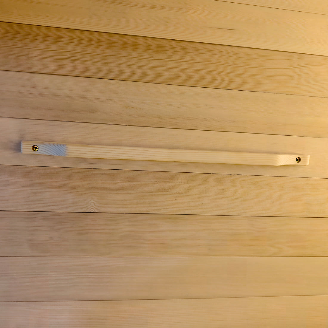 Wooden handle mounted on a wooden paneled wall