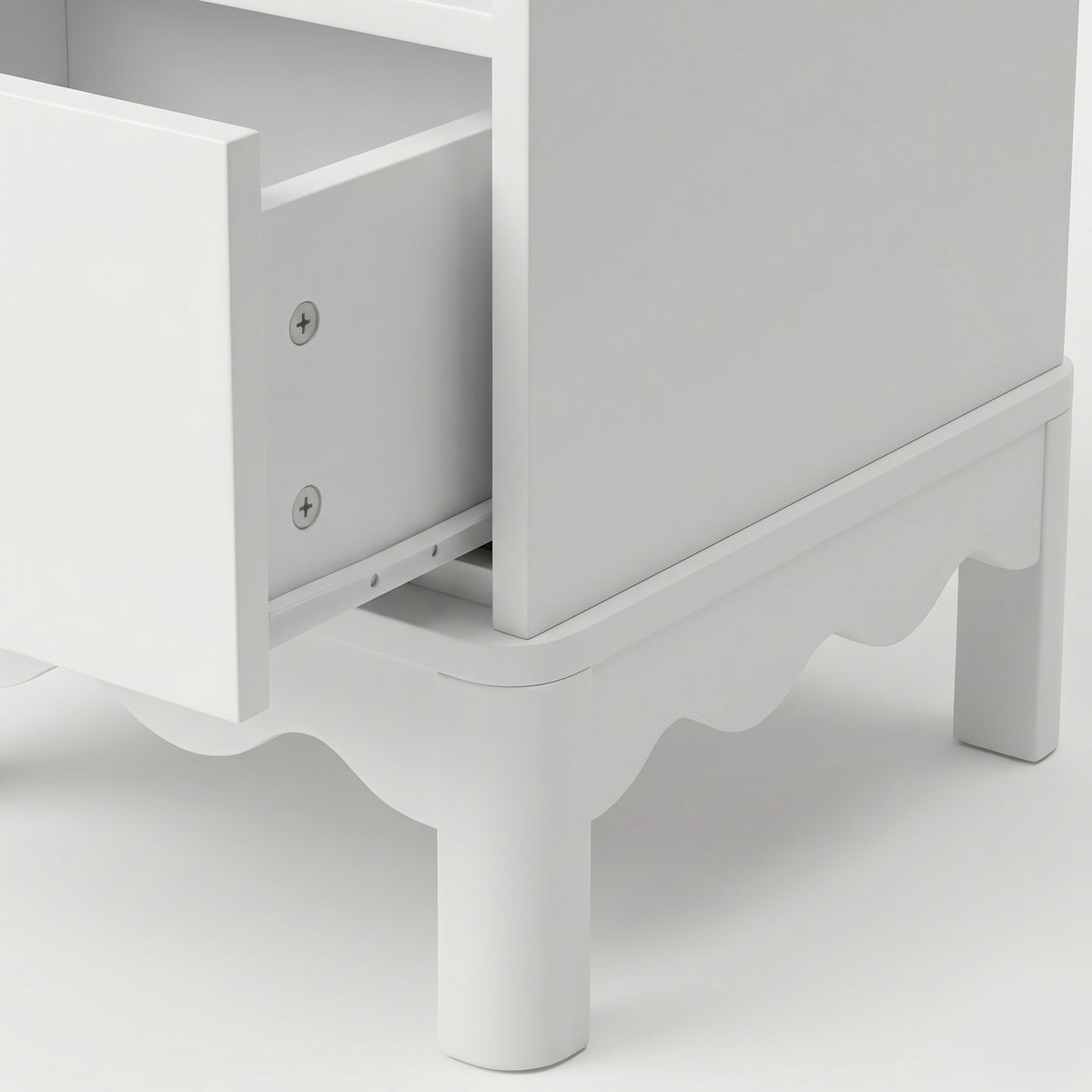 Close-up of an open drawer on white dresser