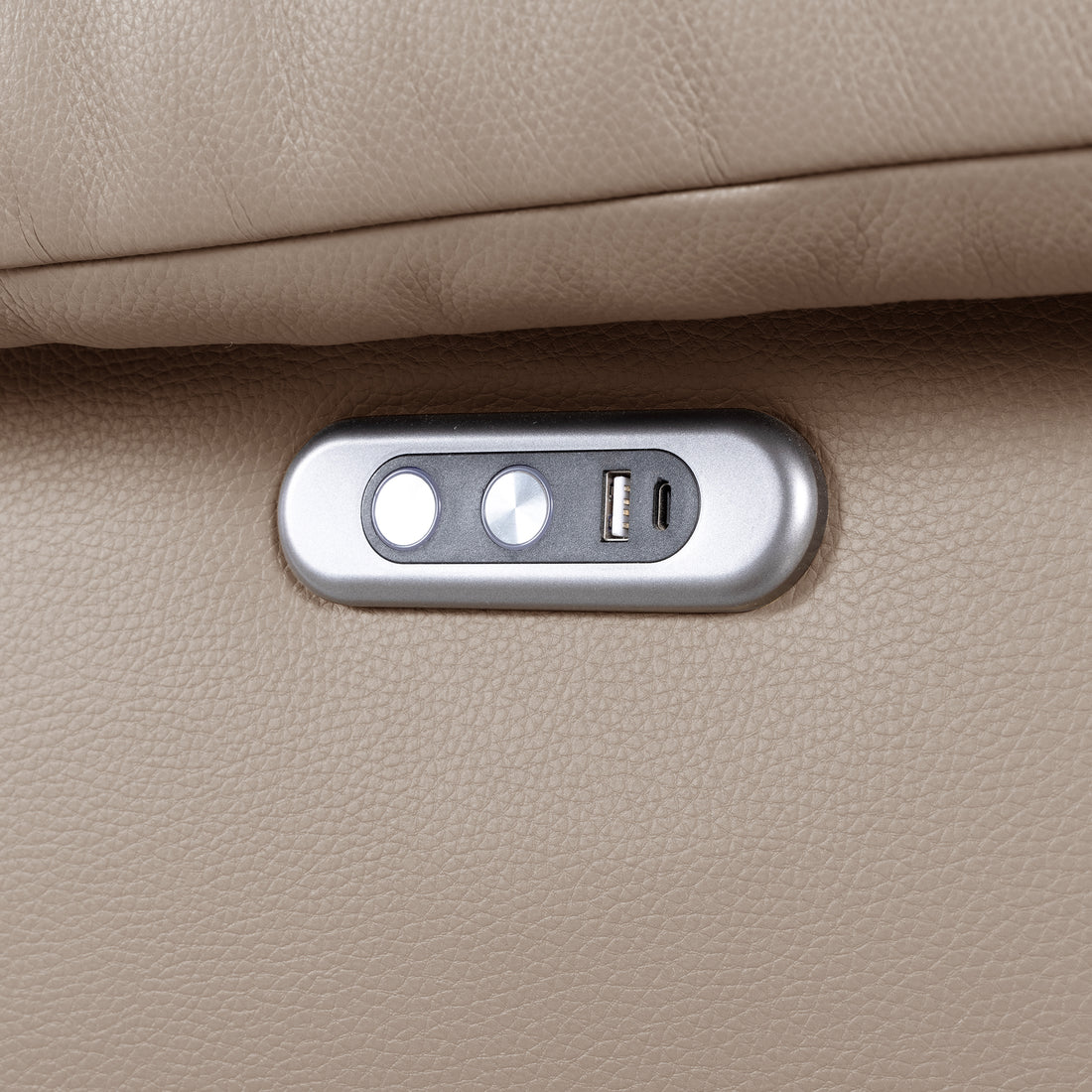 Close-up of a sofa control panel with buttons and USB port in beige upholstery
