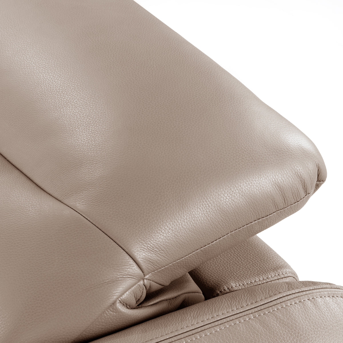 Close-up of taupe leather sofa armrest and seat stitching on white background