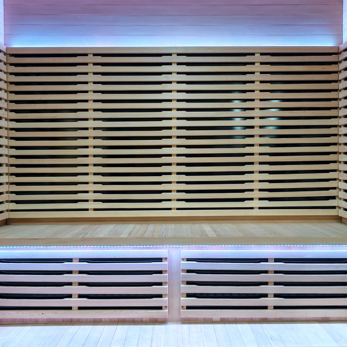 Interior view of a modern sauna with wooden slats and LED lighting