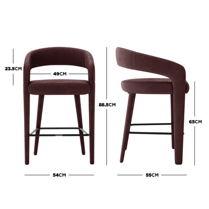 Eisha Velvet Bar Stool Set of 2 in Dark Plum, showing front and side views. Features deep burgundy velvet upholstery, curved open-back design, tapered legs, and black metal footrest with key measurements highlighted. - Dimensions