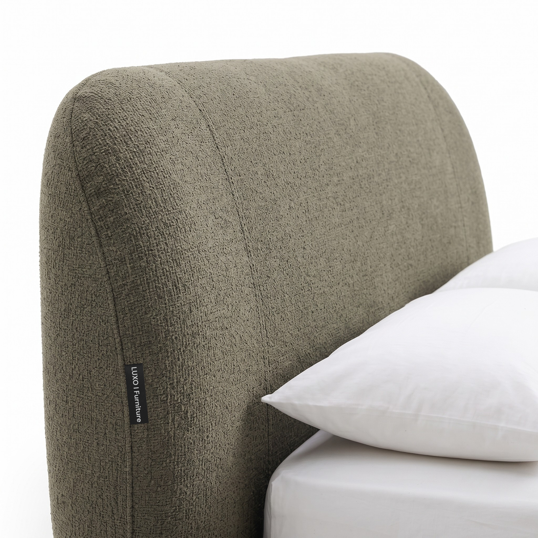 Close-up of upholstered bed headboard on a white background