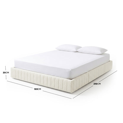 Upholstered bed with mattress and pillows on white background with dimension lines