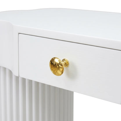 Close-up partial view of a white console table drawer and ribbed leg with gold knob on a white background