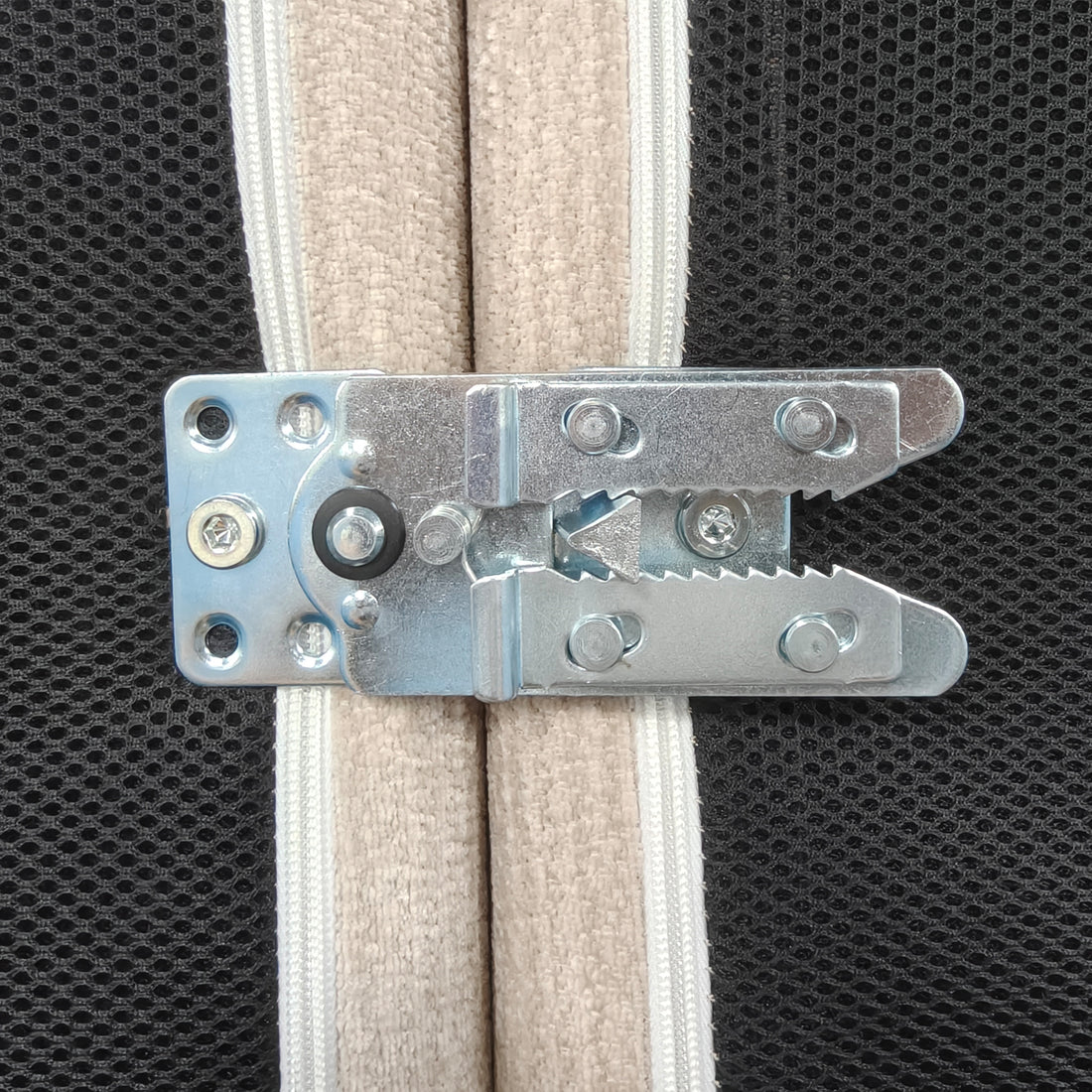 Close-up of metal connector hardware on fabric-covered furniture