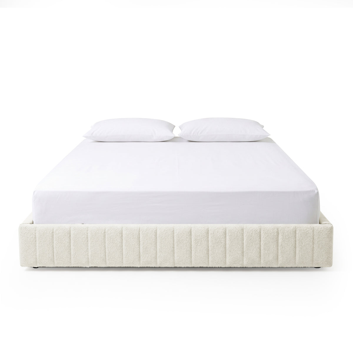 Front-facing upholstered bed with white bedding on white background