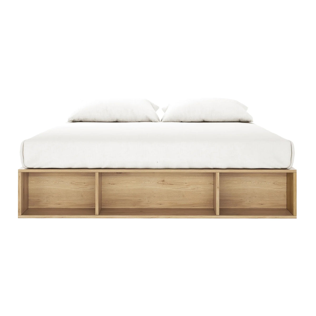 Eulalia King Platform Bed Base with Drawers in Oak features a sleek, low-profile design with a light wood base, white mattress, and pillows, plus three open shelves for storage.