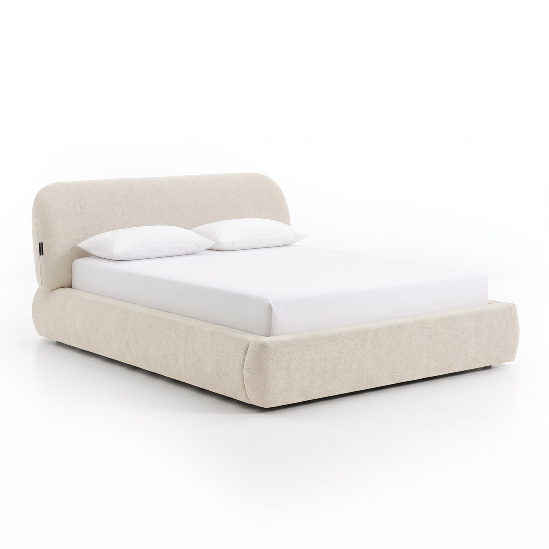 Cream upholstered bed photographed on a white background