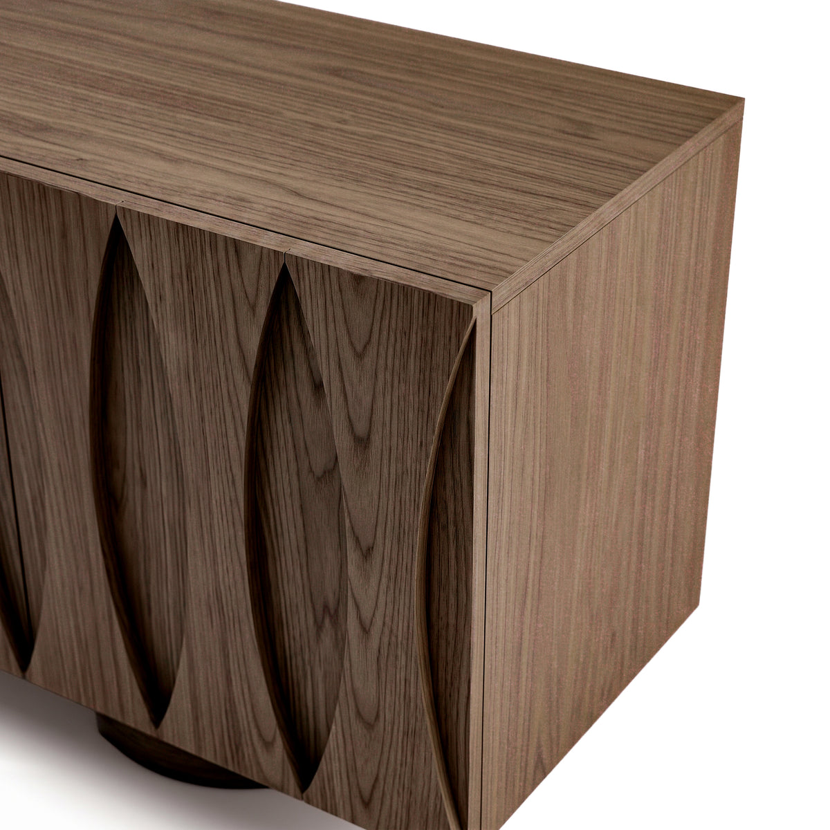 Partial view of a wooden cabinet on a white background
