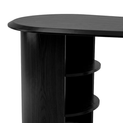 Close-up partial view of a black desk corner and shelving on a white background