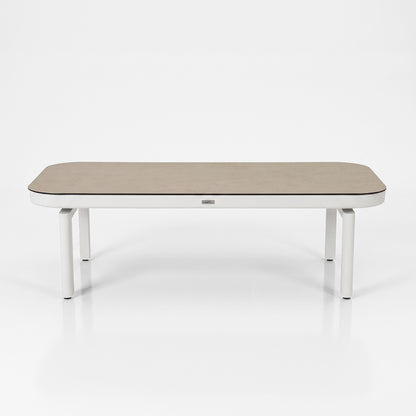 Modern rectangular table with rounded edges on a white background.