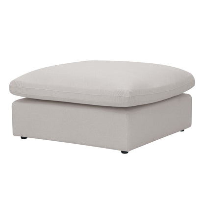 Square light beige upholstered ottoman on a white background