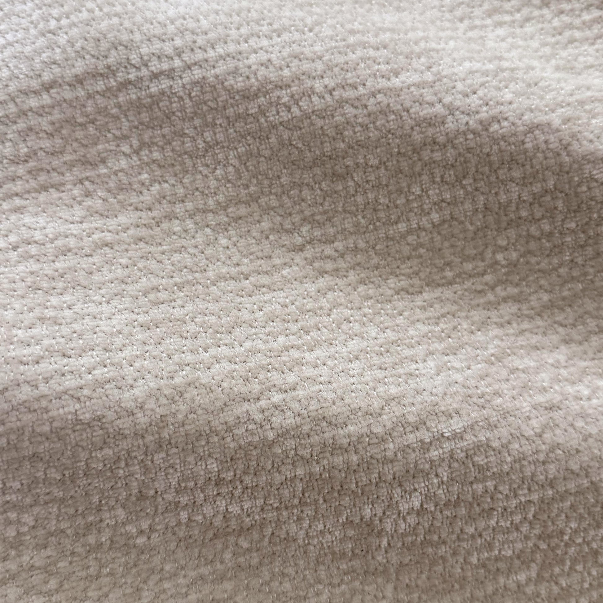 Close-up of beige textured upholstery fabric