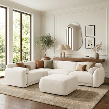 Cream sectional sofa with ottoman in a styled living room