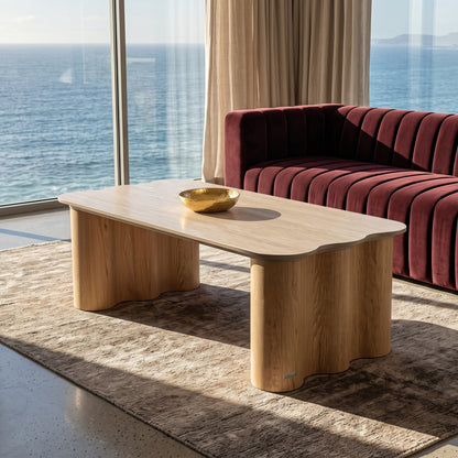 Wooden coffee table in a modern living room with ocean view