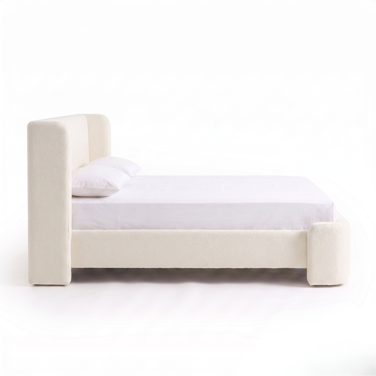 Side view of upholstered bed on a white background