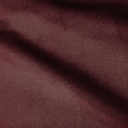 Extreme close-up of burgundy velvet fabric texture