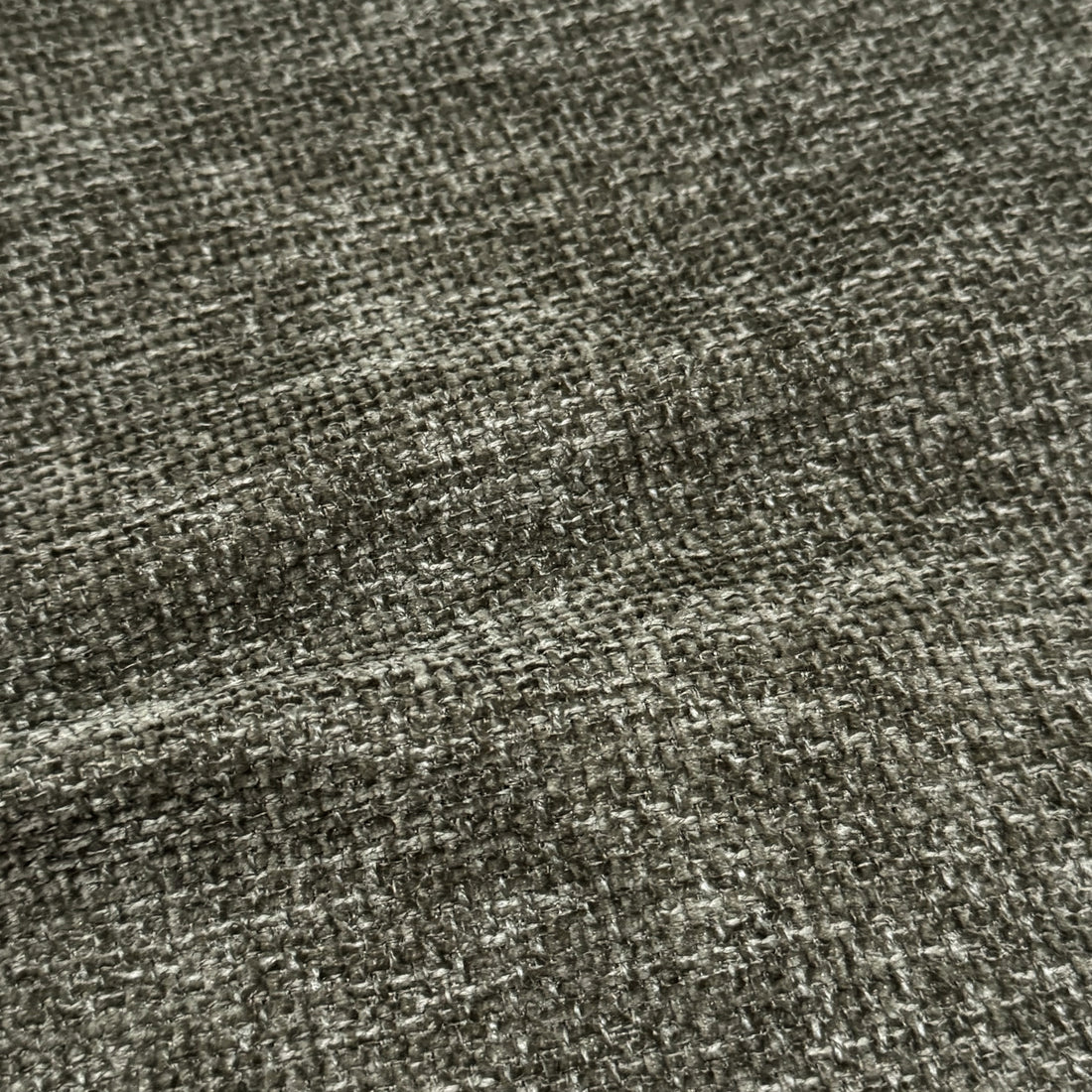 Close-up of woven fabric texture on the bed