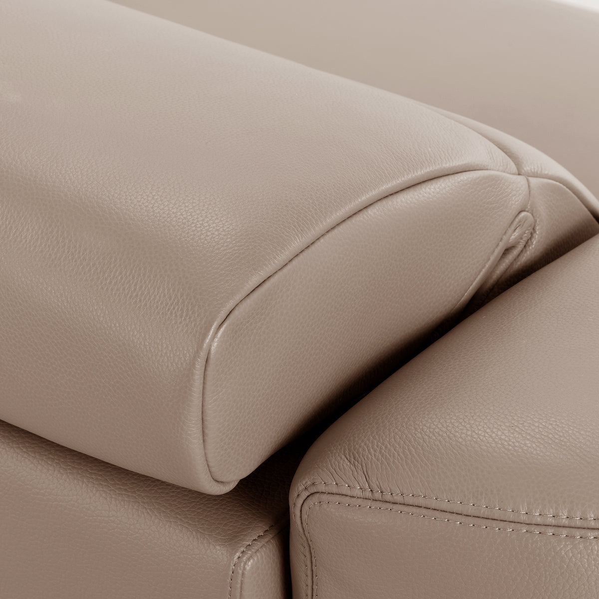 Close-up of beige leather upholstered headrest or armrest detail