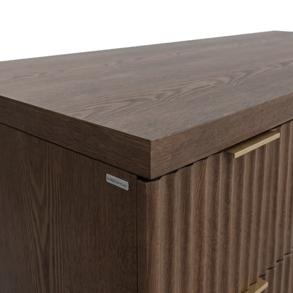 Corner detail of a dark wood cabinet or desk on a white background