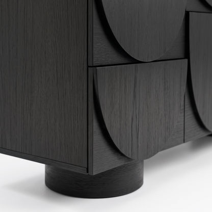 Close-up of the lower corner and base of a black sideboard